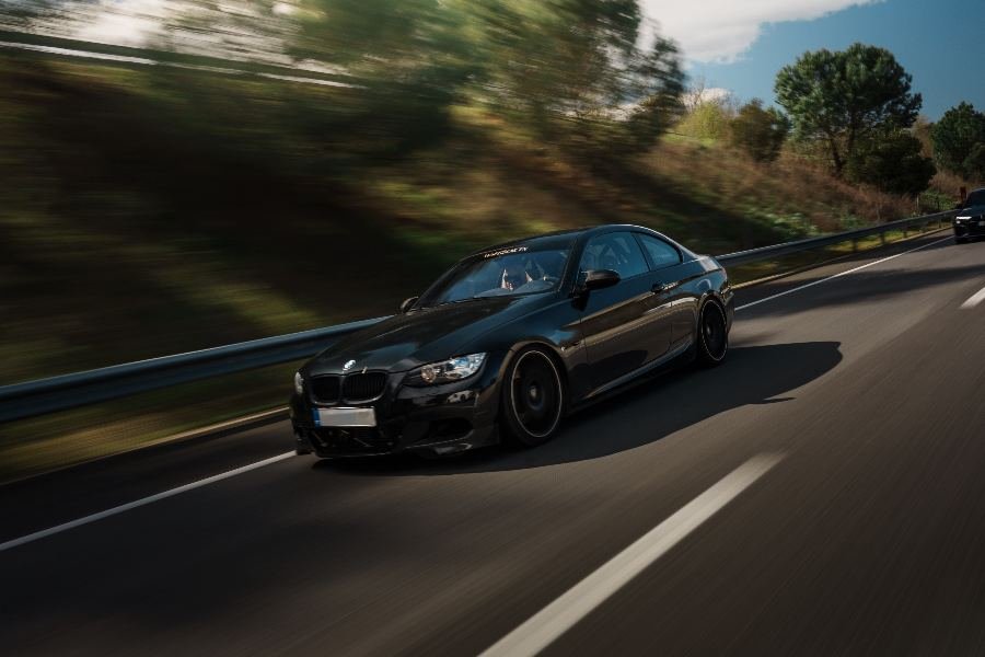Black BMW 335i E92 rolling shot on the highway